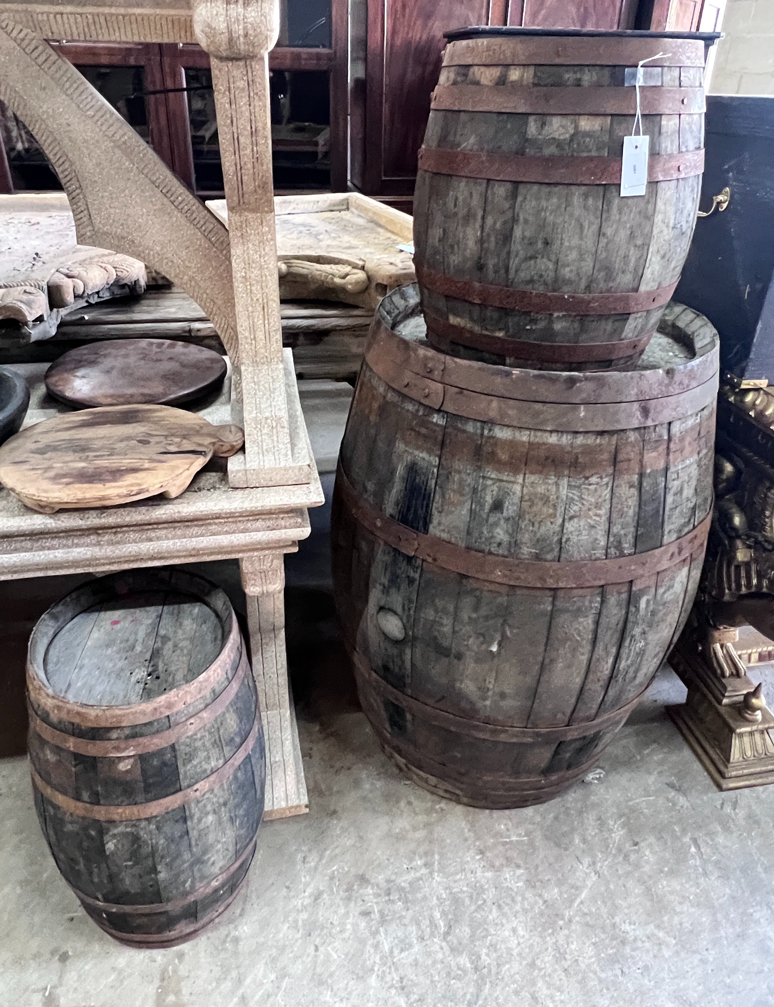 Three iron bound staved wood barrels, largest height 98cm